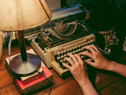 A person typing down their memoir