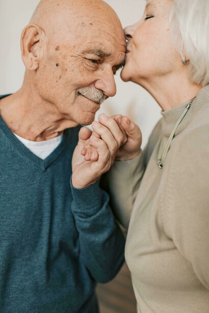 An elderly couple holding hands, capturing a quiet moment of intimacy and enduring love