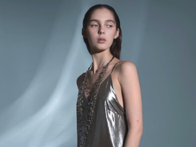 A model shines in a shimmering silver dress, symbolising the fusion of local Brazilian craftsmanship and global fashion innovation that will define the future of style