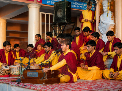 Young Vedic students engaged in the Ganga Aarti ceremony at Parmarth Niketan Ashram, Rishikesh