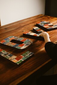 Tiles that spell out 'love' on a table