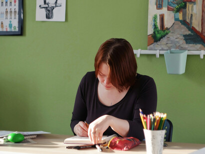 A red-haired woman studying