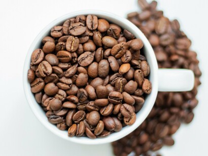 Carefully roasted coffee beans in a cup, reflecting the appreciation for quality coffee across generations