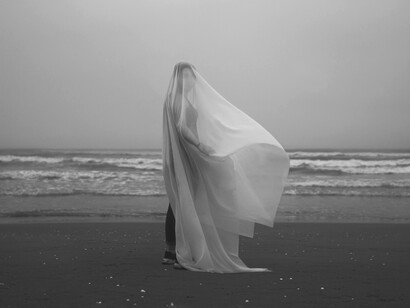 Where the sea meets secrecy, she lingers in quiet grace