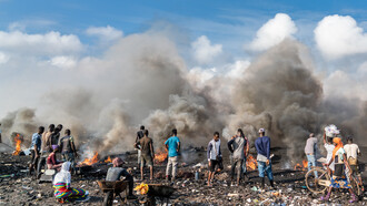 Young men burning electrical wires to recover copper at Agbogbloshie, Accra, Ghana by Muntaka Chasant, CC BY-SA 4.0