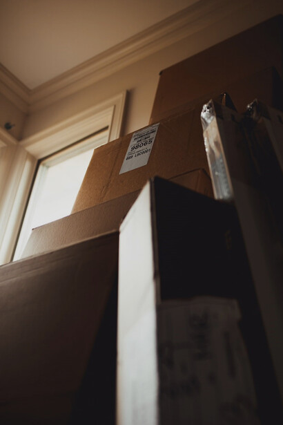 Anticipation hung in the air as an array of neatly packed boxes stood ready, eager to be transported to an unknown destination, signaling the beginning of a fresh chapter