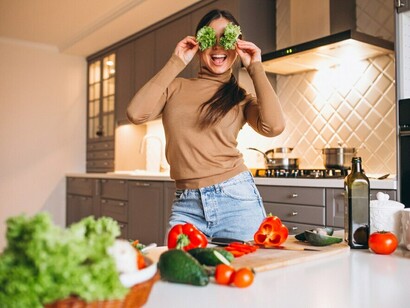 Preparing a wholesome plant-based dish in the kitchen, showcasing fresh fruits and vegetables for a balanced vegan diet