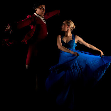 Elegant flamenco dancers performing under dramatic lighting