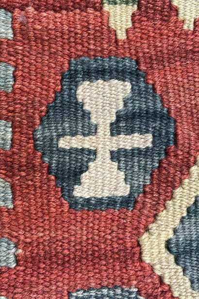Hairband motif, detail. It symbolizes that the weaver of the carpet is an unmarried young woman. From a carpet depicting a young woman's expectations and desires for life as she prepares to marry. Made for an unmarried young woman's dowry. Middle Anatolia, Kayseri, Turkey. 20th century. Private collection