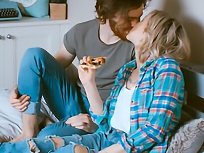 Man and woman kissing on bed