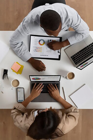 Two people with opposing personalities—an introvert and an extrovert—working together in an office, showcasing the power of collaboration and social interaction