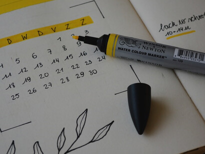 A vibrant blue marker making its mark on a blank sheet of white printer paper