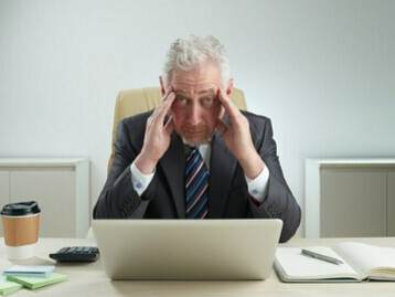 Experienced businessman in the workplace, the role of baby boomers at work, and achieving work-life balance