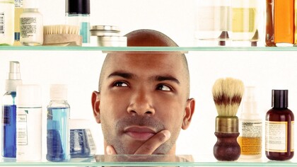 A man thinking about which product to pick up for his daily self-care routine
