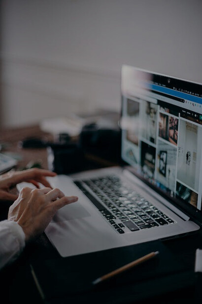 A person actively engaged with a notebook computer for productivity