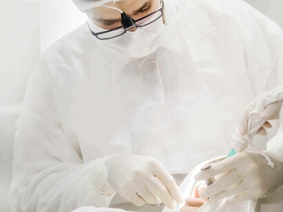 A dentist is carefully examining which area to tackle first before applying the SMART strategy