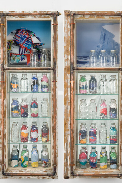 
Window on the World - Antarctica, 2007
Diptych window frames, Lambda photograph laminated, mirror, glass, 38 plasma bottles, used clothes, flags, copper pipes, 2 taps, 105 x 17 x 134 cm
Courtesy of the artists. Photo: Bertrand Huet
