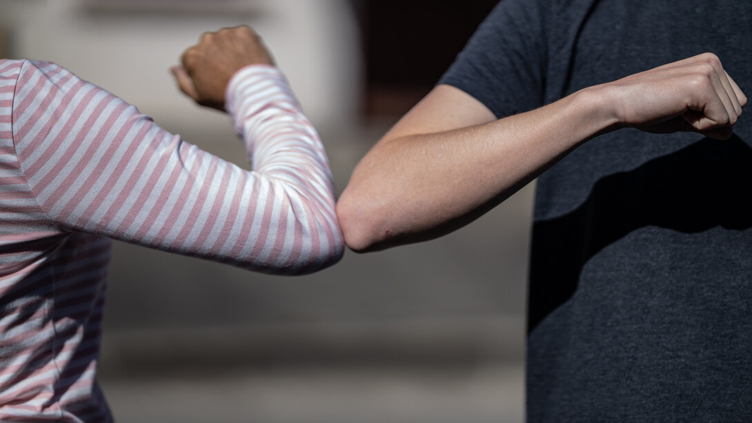 People no longer greet each other by shaking hands and kissing