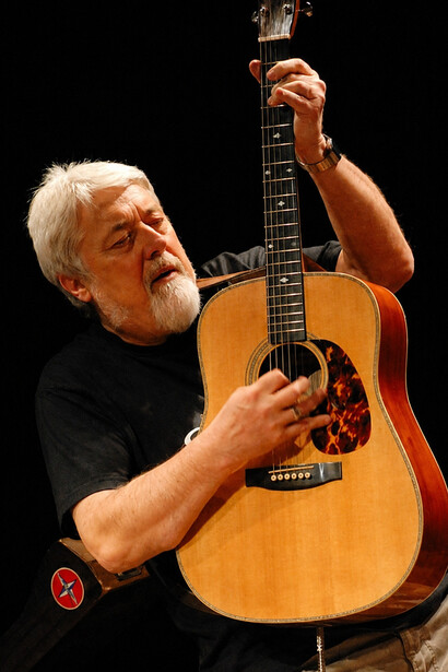 Marcello Capra performing in concert, showcasing the expressive guitar style that has defined his career
