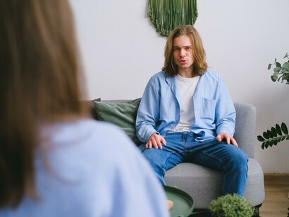 A man in a blue shirt speaking to someone about his OCD