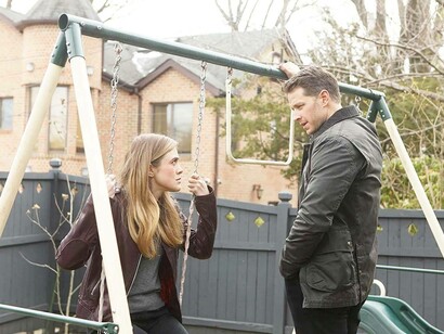 In a scene from the Netflix show, 'Manifest' where Michaela (Melissa Roxburgh) is sitting on a swing and Ben (Josh Dallas) is attempting to discuss something of notable seriousness