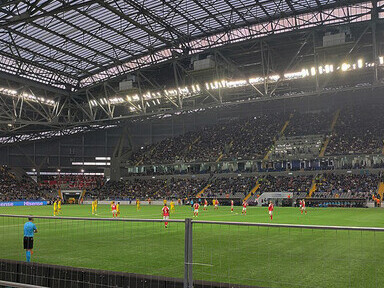 The photo captures the beginning of the UEFA Euro 2024 qualifying match between Kazakhstan and Denmark, held at the Astana Arena in Astana, Kazakhstan