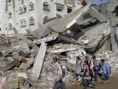 Children walk through debris following an Israeli attack in Gaza in 2012, Palestine