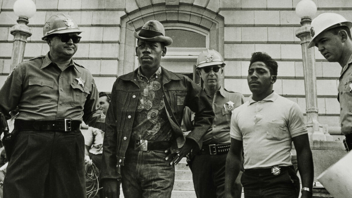 Danny Lyon (American, born 1942), Sheriff Jim Clark arrests two SNCC voter registration workers on the steps of the federal building, Selma, Alabama, 1963, printed later, Gelatin silver print, h. 11 in. (27.9 cm); w. 14 in. (35.6 cm), San Antonio Museum of Art, gift of Ernest Pomerantz and Marie Brenner, 2017.25.42, © Danny Lyon / Magnum Photos