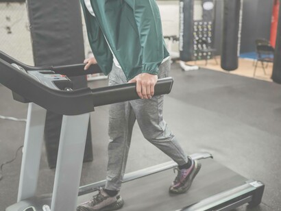 A man on a treadmill winding down after a successful workout