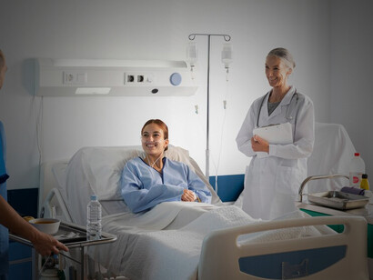 A patient receiving intravenous treatment with medical equipment and nurse support