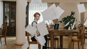 An professional surrounded by floating papers, showing how excessive planning can hinder meaningful progress