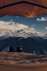 A view from a brown dome tent overlooking the Himalayas in Nepal