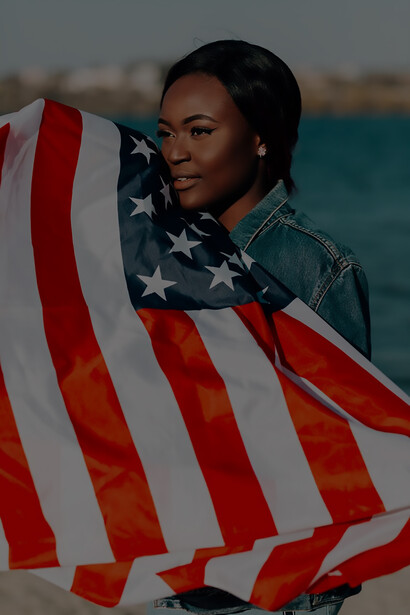 In a powerful display of patriotism and pride, a Black woman gracefully holds American flags in her hands