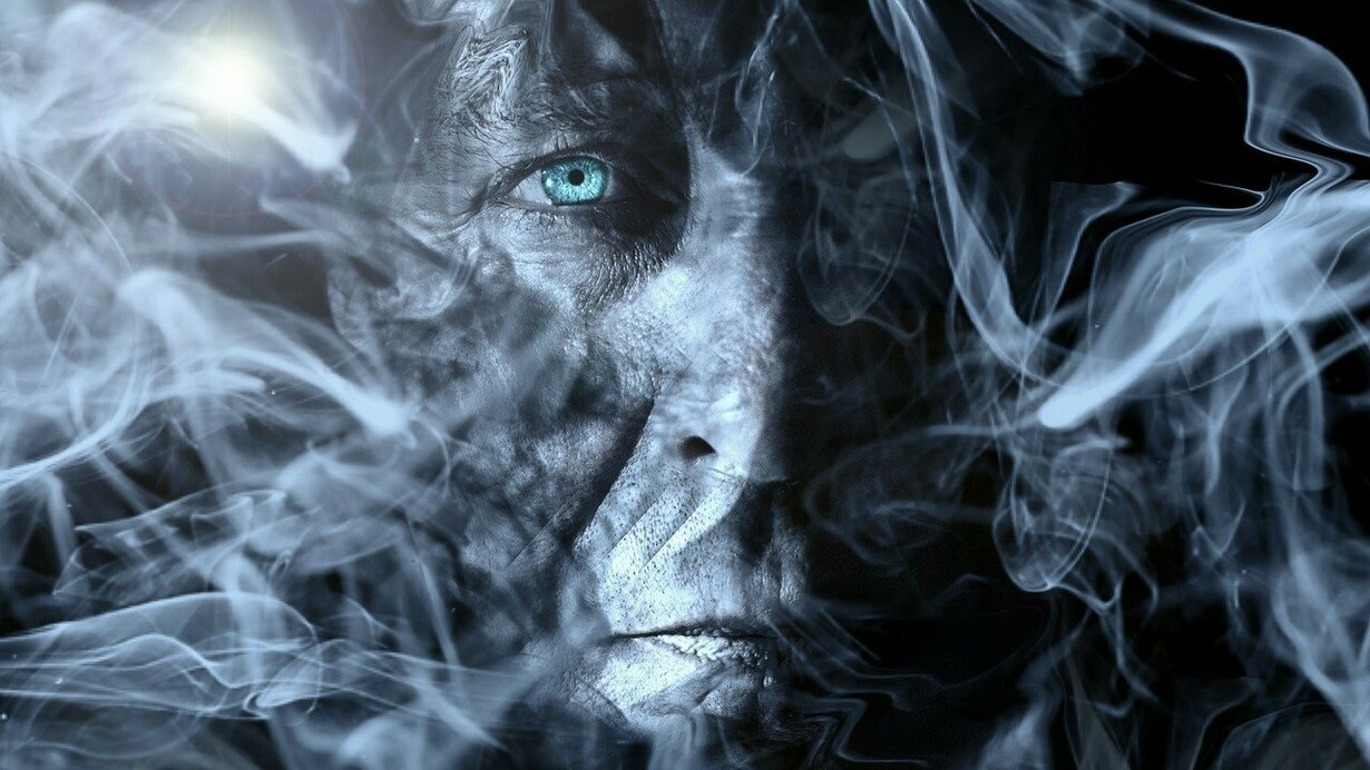 A face shrouded in smoke, showing a hint of human suffering and vulnerability