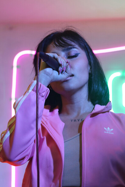 Learning languages through songs — a girl practices by singing karaoke in a bar, combining fun with effective language immersion