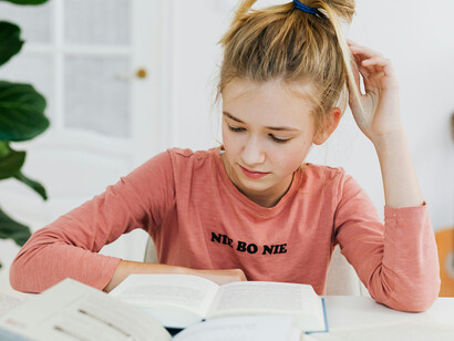 A girl with her head in her hands, struggling to stay engaged while the purpose drifts