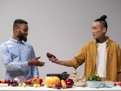 Two people preparing a fresh meal together, representing the connection between mindful nutrition and shared wellbeing