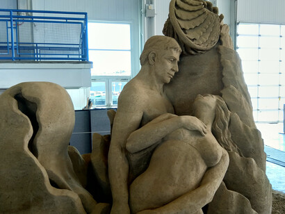 Sand sculpture, woman looking up at a man