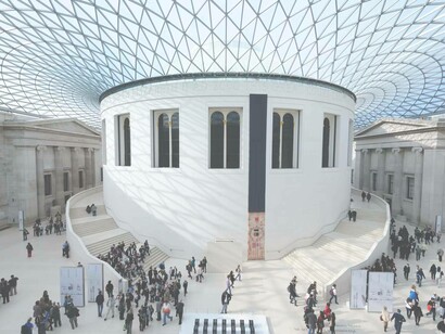 The entrance hallway of the British Museum with a healthy crowd of people making their way to the next halls 
