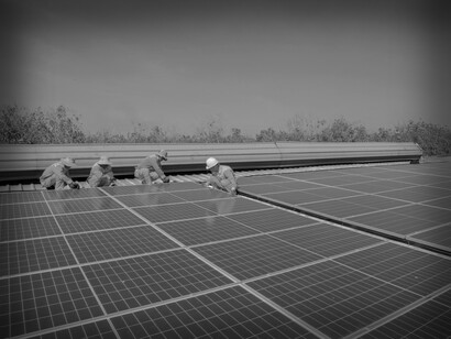 A solar crew of four adjusts the panels during the installation