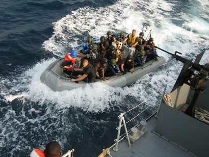 A crew of U.S. sailors and Nigerian special forces fighters prepares to board the NNS Burutu for a training exercise