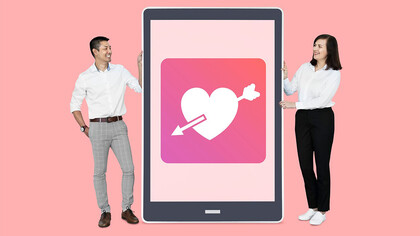 A couple viewing a dating app on a tablet, exploring online dating together