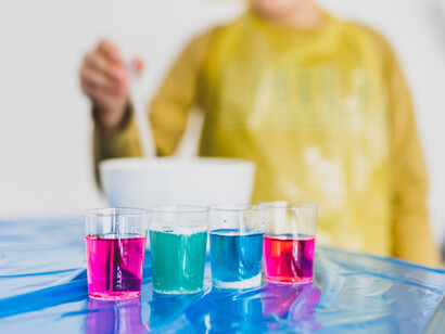 A child lines up several samples of liquids in his science experiment