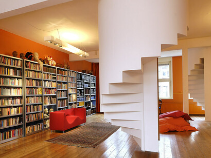 The bold blue structures of Didden Village in Rotterdam, Netherlands, stand in striking contrast to the traditional red-brick façade below