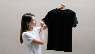 A woman displaying a sleek black t-shirt