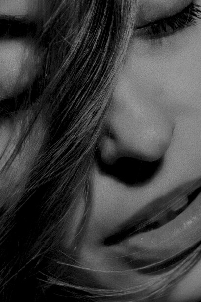 A stunning portrait of a woman with black hair, highlighting her natural beauty and sensual charm