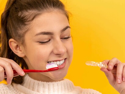 Teenage girl brushing her teeth