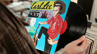 A person looking closely at a vinyl record