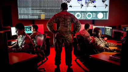 Capt. Taiwan Veney, a cyber warfare operations officer, oversees the 175th Cyberspace Operations Group as they analyze log files and present a cyber threat update using Kibana at Warfield Air National Guard Base, Md., on June 3, 2017