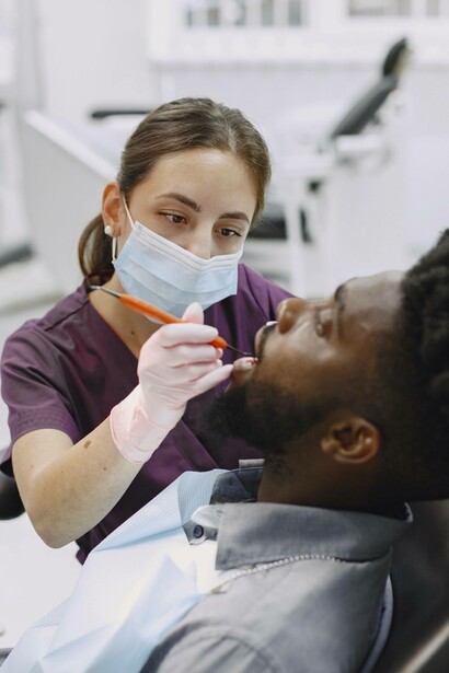 Dentist concentrates as she examines patient